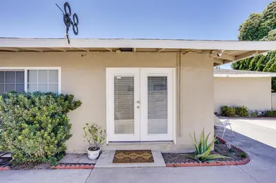 a house with a white door and plants at Explore SoCal! Cozy Retreat Near Disney and Beaches in Westminster