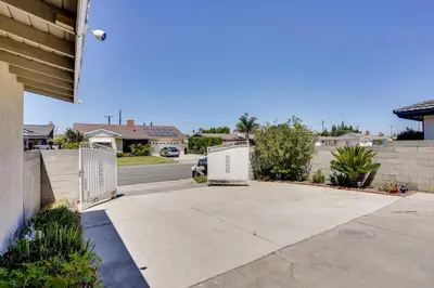 a driveway with a gate in a house at Explore SoCal! Cozy Retreat Near Disney and Beaches in Westminster