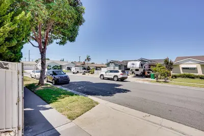 a street with cars parked on the side of the road at Explore SoCal! Cozy Retreat Near Disney and Beaches in Westminster
