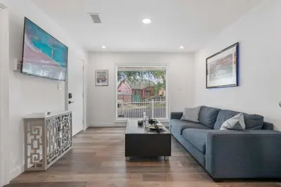 a living room with a blue couch and a table at New Listing City Bungalow by Colby & Conrad in Los Angeles
