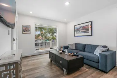 a living room with a blue couch and a table at New Listing City Bungalow by Colby & Conrad in Los Angeles