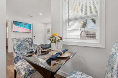 a dining room with a glass table and a chair at New Listing City Bungalow by Colby & Conrad in Los Angeles