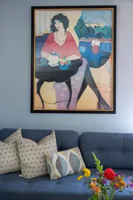a painting of a woman holding a table in a living room at Venice Beach Cottage Retreat in Los Angeles