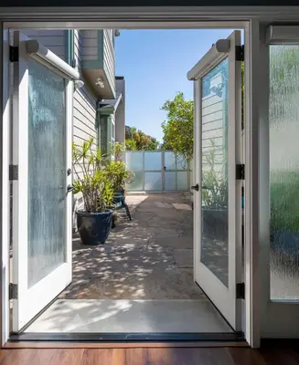 an open door leading to a patio with plants at Venice Beach Cottage Retreat in Los Angeles