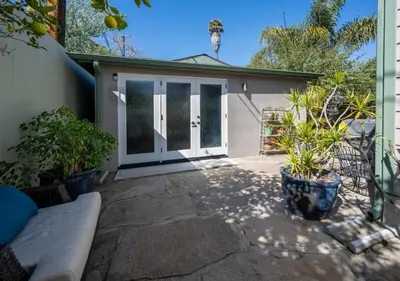 a patio with a couch in front of a garage at Venice Beach Cottage Retreat in Los Angeles