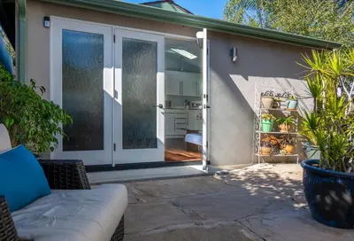 an open sliding glass door of a home with a patio at Venice Beach Cottage Retreat in Los Angeles