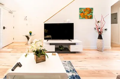 a living room with a large flat screen tv at Modern 1-Bedromm Loft In Hollywood With Viwe of Hollywood Sign in Los Angeles