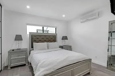 a bedroom with a large bed with two night stands at Mansfield Modern in Los Angeles