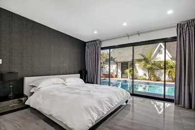 a bedroom with a large bed and a swimming pool at Mansfield Modern in Los Angeles