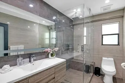 a bathroom with a sink and a toilet and a shower at Mansfield Modern in Los Angeles