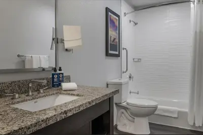 a bathroom with a toilet and a sink and a tub at Dolphin's Cove in Anaheim