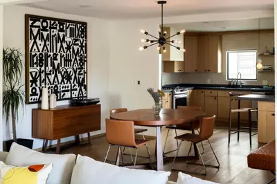 a kitchen and living room with a table and chairs at NEW! High-End Spanish Duplex | Luxury 3BR in Los Angeles