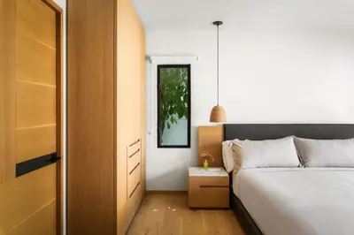 a small bedroom with a bed and a mirror at NEW! High-End Spanish Duplex | Luxury 3BR in Los Angeles