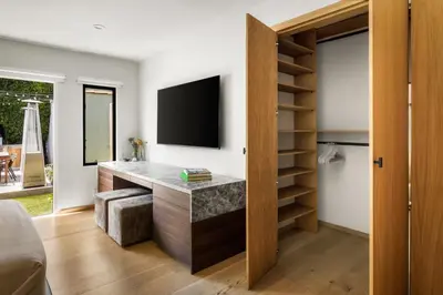 a living room with a desk with a television at NEW! High-End Spanish Duplex | Luxury 3BR in Los Angeles