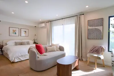 a bedroom with a bed and a couch and a chair at New Venice Beach Zen Hideaway in Los Angeles