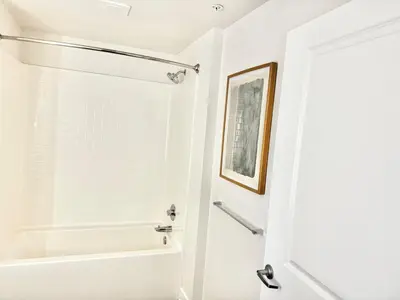 a white bathroom with a shower and a tub at 242 Charming, Peaceful Apartment Retreat in Griffith in Glendale
