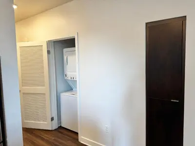 a room with a refrigerator and a washer and dryer at 242 Charming, Peaceful Apartment Retreat in Griffith in Glendale