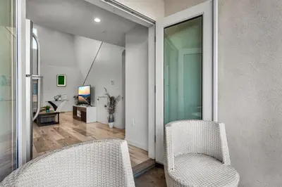 a living room with two white chairs and a living room at Loft-Style 1-Bedroom Apartment with Balcony & Private Parking in Hollywood in Los Angeles