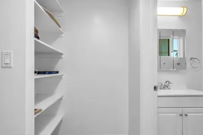 a white kitchen with a sink and a white cabinet at Lux Hollywood Loft 1BR with Balcony & Private Parking 10 Min to Downtown LA in Los Angeles