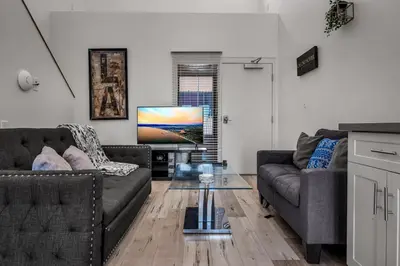 a living room with two couches and a television at Lux Hollywood Loft 1BR with Balcony & Private Parking 10 Min to Downtown LA in Los Angeles