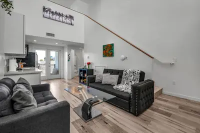 a living room with a couch and a table at Lux Hollywood Loft 1BR with Balcony & Private Parking 10 Min to Downtown LA in Los Angeles