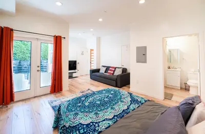 a living room with a bed and a couch at Chic Hollywood Koreatown 3Bedroom Loft 3 Level 2 Bathrooms Perfect for Groups up to 10 in Los Angeles