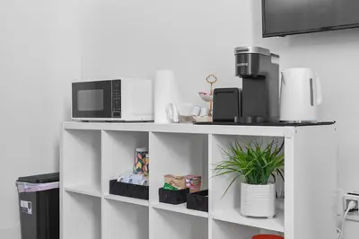 a white shelf with a microwave and a coffee maker at Modern 1BR Suite w AC Sleeps 3, NW Bakersfield in Bakersfield