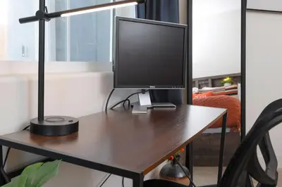 a computer monitor sitting on top of a desk at Modern 1BR Suite w AC Sleeps 3, NW Bakersfield in Bakersfield
