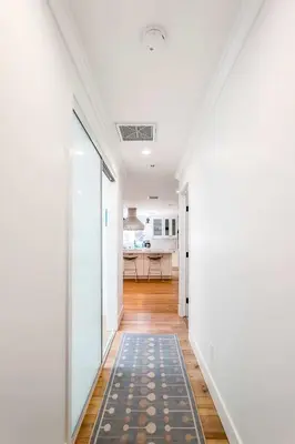 a hallway with white walls and a rug at Spacious 4BR Games Workspace Outdoor Fun in Los Angeles