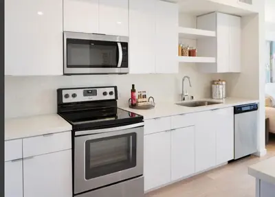 a white kitchen with a stove and a microwave at LAX 1 Bed Luxe with FREE PARKING in Los Angeles