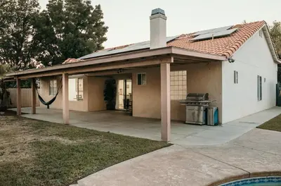 a covered patio with a grill in a house at Stunning Home with Pool, Game Room and Firepit in Bakersfield