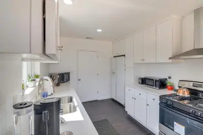 a kitchen with white cabinets and a stove top oven at HOV Lux Whitehouse Lakeview Terrace