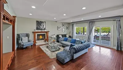 a living room with a couch and a fireplace at Gorgeous Villa with Private Heated Pool in Garnsey