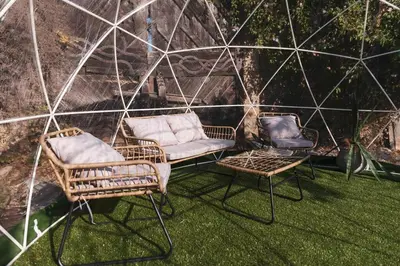 two chairs and a couch in a greenhouse at Mid-Century Modern Hillside Escape With Dome and Views in Los Angeles