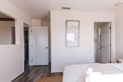 a white bedroom with white walls and a white bed at Mid-Century Modern Hillside Escape With Dome and Views in Los Angeles
