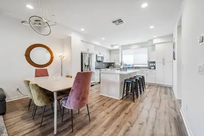 a kitchen and dining room with a table and chairs at NoHo Modern Townhouse with Gorgeous Rooftop in Van Nuys
