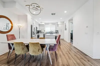 a kitchen and dining room with a table and chairs at NoHo Modern Townhouse with Gorgeous Rooftop in Van Nuys