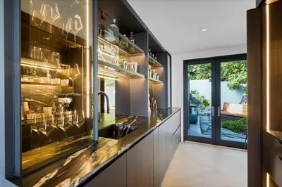 a kitchen with a counter with a glass wall at White Lotus by Stay Awhile Villas in Los Angeles
