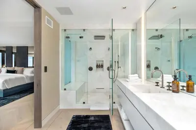 a bathroom with a shower and a sink and a tub at White Lotus by Stay Awhile Villas in Los Angeles