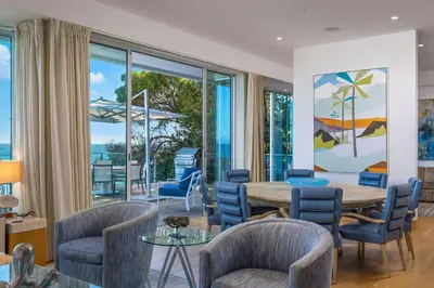 a dining room with a table and chairs at Casa Mare by Stay Awhile Villas in Malibu Beach