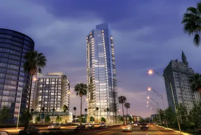 a tall building with palm trees and cars on a city street at Aqua Marina Oceanfront Escape in Long Beach