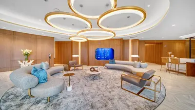 a lobby with couches and chairs and a large chandelier at Aqua Marina Oceanfront Escape in Long Beach