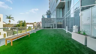 an apartment with a green lawn on the balcony at Aqua Marina Oceanfront Escape in Long Beach
