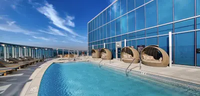 a hotel with a swimming pool on a building at Aqua Marina Oceanfront Escape in Long Beach