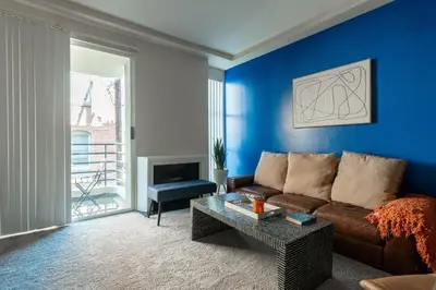 a living room with a brown couch and a blue wall at Marvelous 2BR 2BA Apartment in Los Angeles