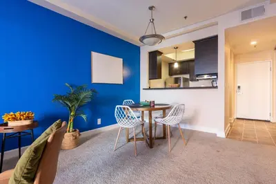 a living room with a blue wall and a table and chairs at Marvelous 2BR 2BA Apartment in Los Angeles