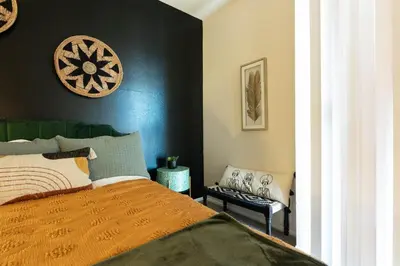 a bedroom with a bed and a black wall at Marvelous 2BR 2BA Apartment in Los Angeles