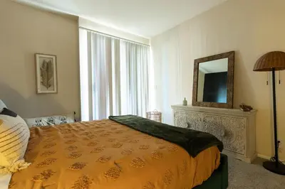 a bedroom with a large bed and a mirror at Marvelous 2BR 2BA Apartment in Los Angeles