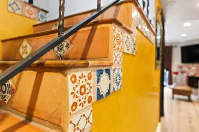 a yellow wall with colorful tiles on it at Allura Studio City Mediterranean with Private Pool in Los Angeles