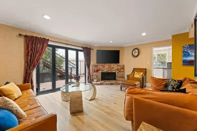 a living room with a couch and a fireplace at Allura Studio City Mediterranean with Private Pool in Los Angeles